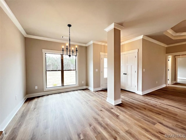 interior space featuring decorative columns, wood-type flooring, and crown molding