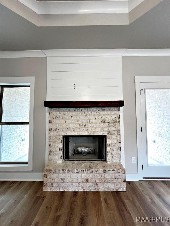 room details with wood-type flooring and a brick fireplace