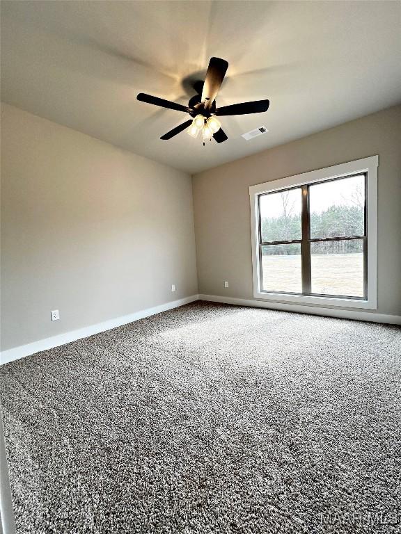 carpeted empty room featuring ceiling fan