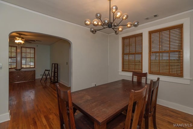 dining room featuring wood-type flooring, ceiling fan with notable chandelier, and ornamental molding