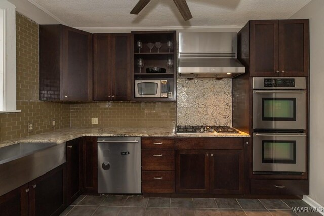 1220 Westmoreland Ave, Montgomery, AL 36106 - kitchen featuring stainless steel appliances, backsplash, light stone countertops, dark brown cabinetry, and a textured ceiling