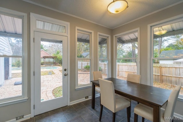1220 Westmoreland Ave, Montgomery, AL 36106 - dining room featuring ornamental molding, dark tile patterned floors, and a textured ceiling
