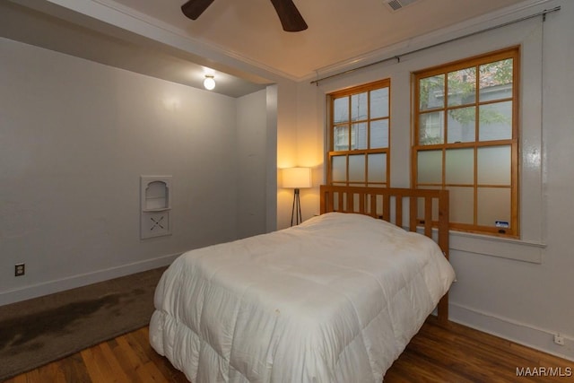 bedroom with dark hardwood / wood-style floors and ceiling fan