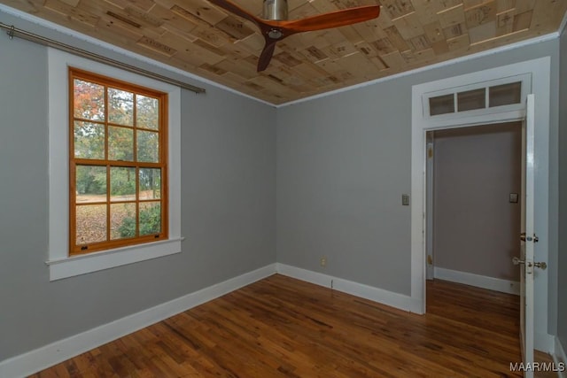 spare room featuring wood-type flooring, ceiling fan, crown molding, and wood ceiling