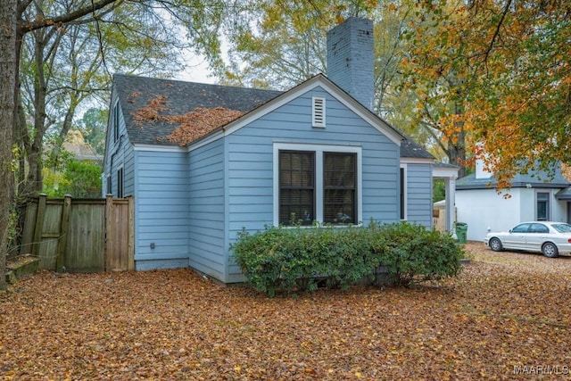 1220 Westmoreland Ave, Montgomery, AL 36106 - view of home's exterior featuring a chimney and roof with shingles