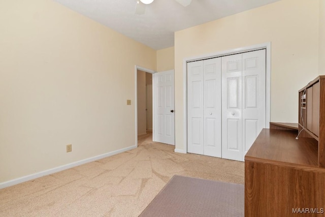 unfurnished bedroom featuring ceiling fan, carpet floors, and a closet