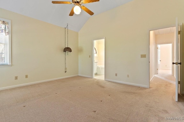 carpeted empty room featuring ceiling fan and high vaulted ceiling