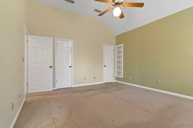 spare room featuring carpet floors, high vaulted ceiling, and ceiling fan