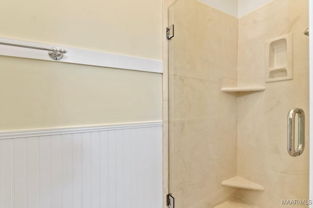 bathroom featuring a shower with door