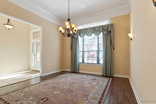 unfurnished room featuring a chandelier, ornamental molding, and dark wood-type flooring