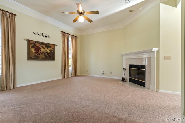 unfurnished living room with ceiling fan, light colored carpet, ornamental molding, and a tiled fireplace