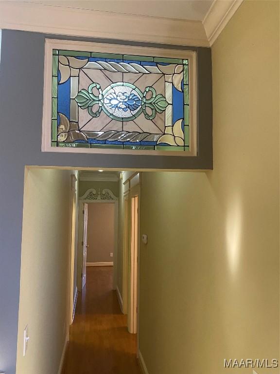 corridor featuring hardwood / wood-style floors and ornamental molding