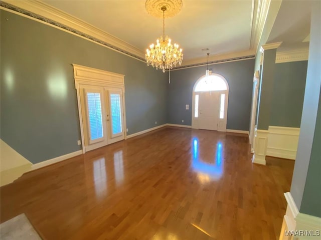 entryway featuring crown molding, plenty of natural light, french doors, and hardwood / wood-style flooring