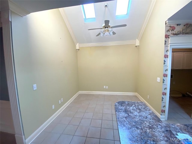 tiled empty room with a skylight, ceiling fan, and crown molding