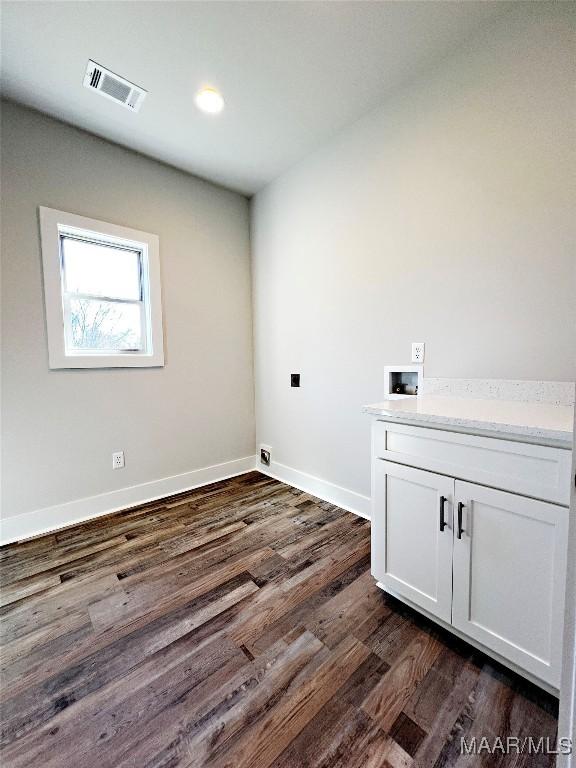 6 Village Knl, Wetumpka, AL 36093 - laundry area with cabinet space, baseboards, dark wood-style flooring, visible vents, and washer hookup