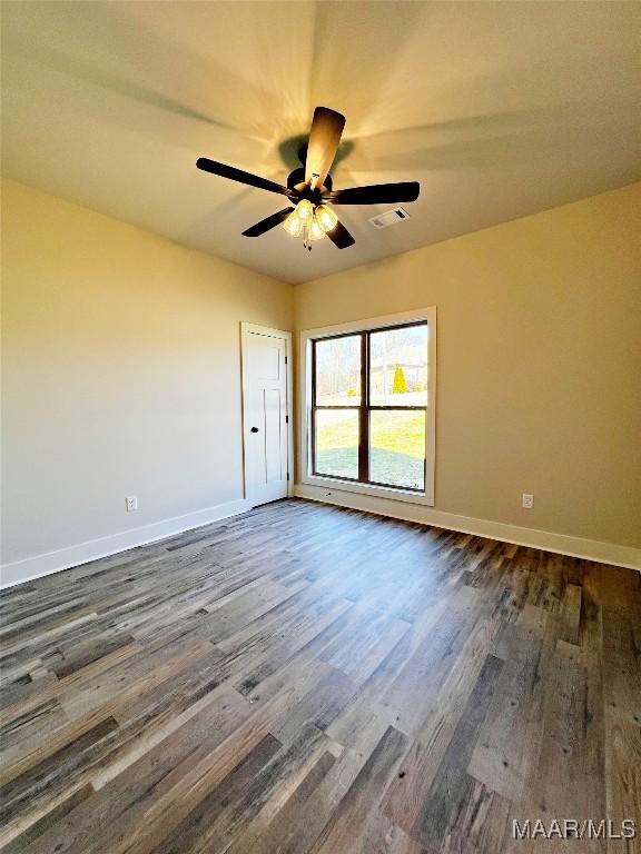 6 Village Knl, Wetumpka, AL 36093 - unfurnished room with dark wood finished floors, baseboards, visible vents, and ceiling fan