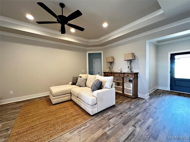 6 Village Knl, Wetumpka, AL 36093 - living area with a tray ceiling, dark wood-style flooring, baseboards, a ceiling fan, and crown molding