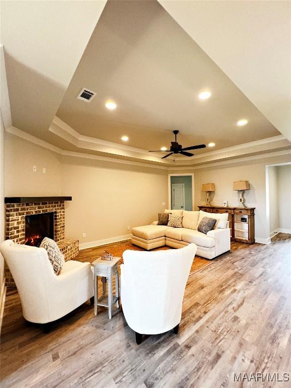 6 Village Knl, Wetumpka, AL 36093 - living area featuring wood finished floors, a ceiling fan, visible vents, and a raised ceiling