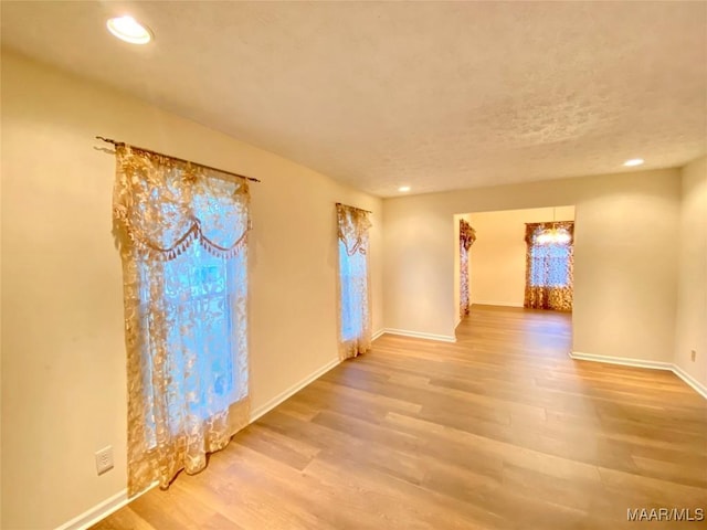 empty room with hardwood / wood-style flooring