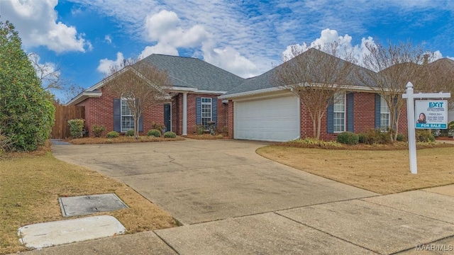 single story home with a garage and a front lawn