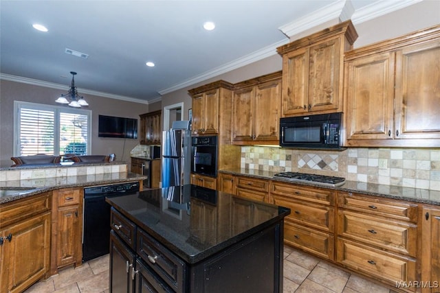 kitchen featuring dark stone counters, black appliances, ornamental molding, a kitchen island, and a chandelier