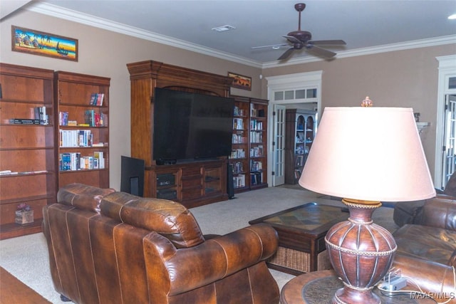 carpeted living room with ceiling fan and crown molding