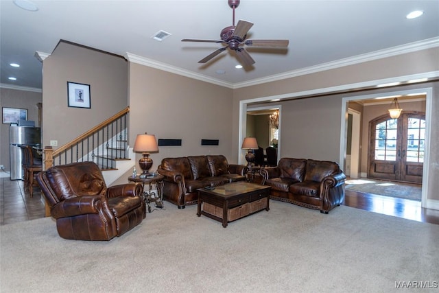 carpeted living room featuring ceiling fan, french doors, and ornamental molding