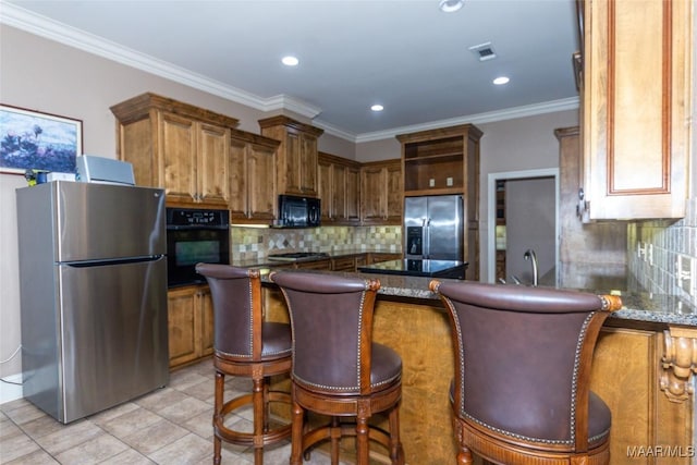 kitchen with tasteful backsplash, dark stone counters, ornamental molding, black appliances, and light tile patterned floors