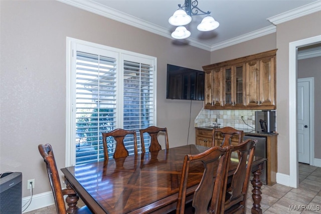 dining space with light tile patterned floors, crown molding, and an inviting chandelier