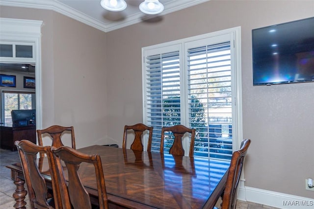 tiled dining area featuring a wealth of natural light and ornamental molding