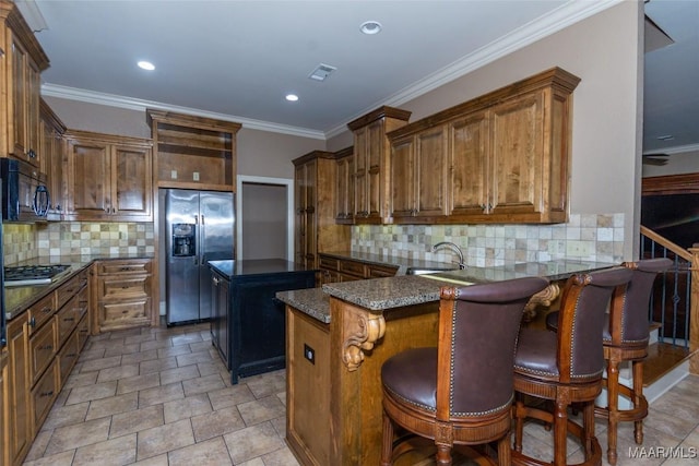 kitchen featuring decorative backsplash, a kitchen island, a breakfast bar area, and appliances with stainless steel finishes