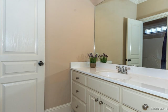 bathroom with crown molding and vanity