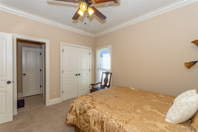 carpeted bedroom featuring ceiling fan and ornamental molding