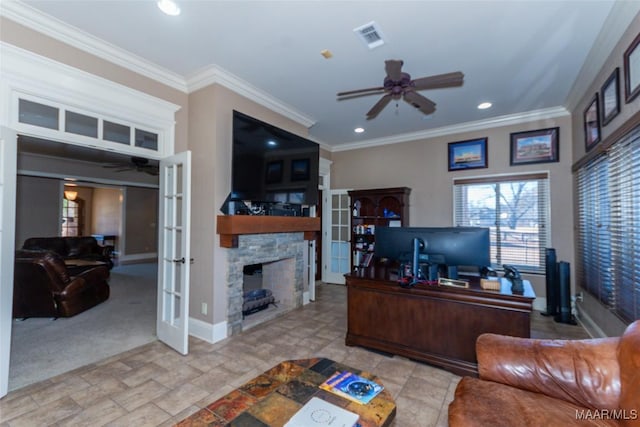 office space featuring a stone fireplace, crown molding, light carpet, and french doors