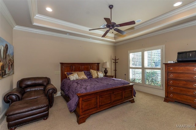 bedroom featuring ceiling fan, light colored carpet, crown molding, and a tray ceiling