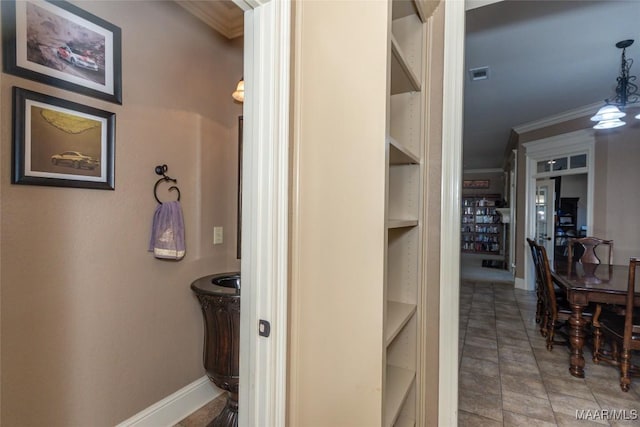 bathroom featuring built in features and crown molding