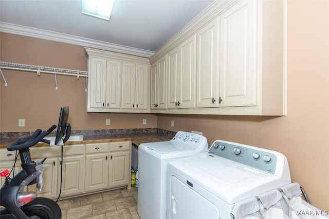 clothes washing area featuring cabinets, independent washer and dryer, and crown molding