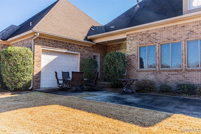 rear view of house with a lawn and a garage