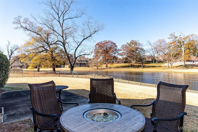 view of patio / terrace with a water view and an outdoor fire pit