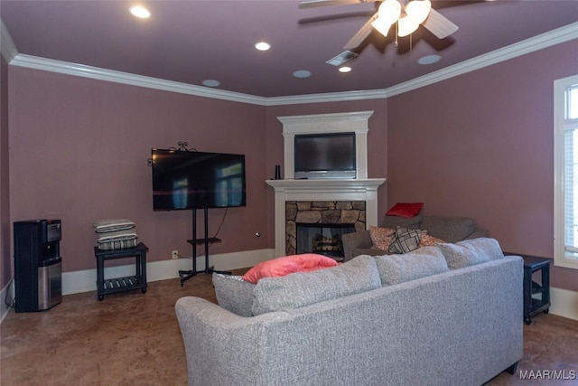 carpeted living room with a stone fireplace, crown molding, and ceiling fan