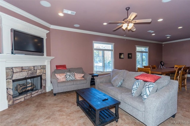 living room with ceiling fan, a fireplace, ornamental molding, and light carpet