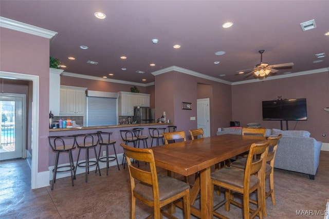 dining space featuring ceiling fan and ornamental molding