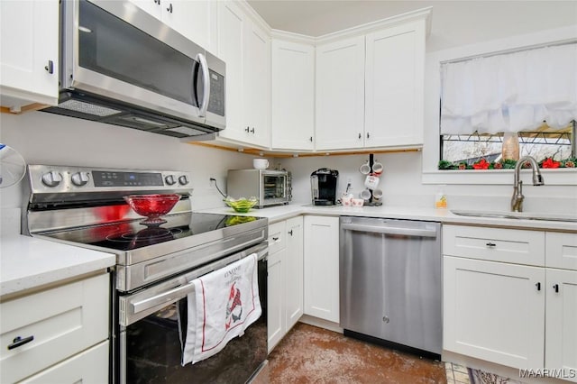 kitchen with white cabinetry, sink, and appliances with stainless steel finishes