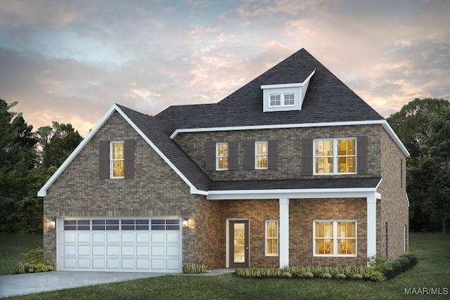 view of front of house featuring a lawn and a garage