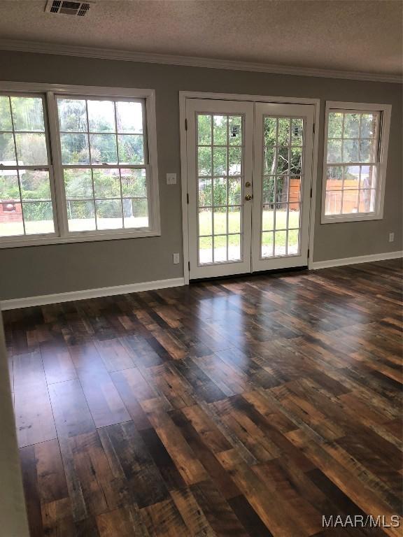 doorway featuring crown molding, french doors, dark hardwood / wood-style floors, and a textured ceiling