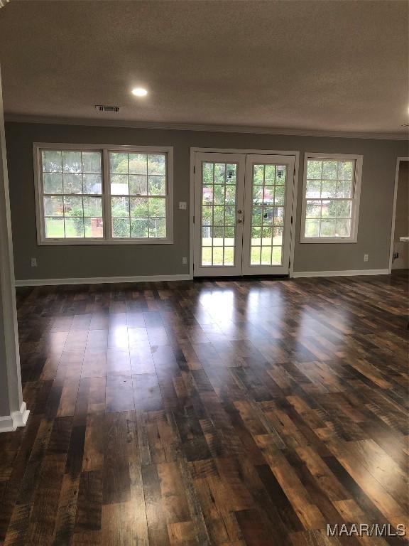 empty room featuring french doors and dark hardwood / wood-style flooring