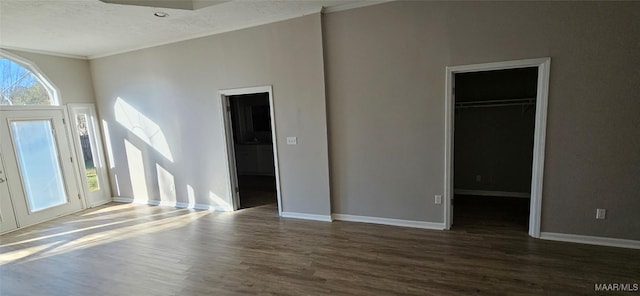 entrance foyer featuring dark hardwood / wood-style flooring and crown molding