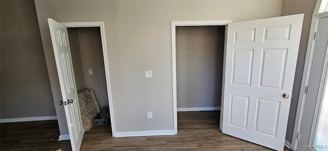 unfurnished bedroom with dark wood-type flooring