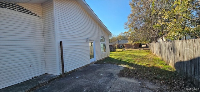 view of side of home with a lawn