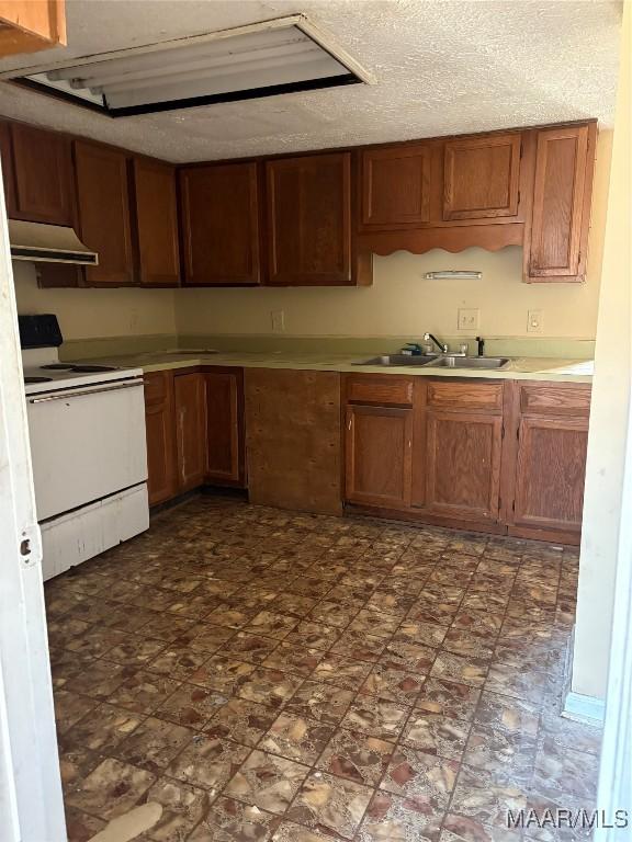 kitchen with sink, white range with electric stovetop, and a textured ceiling